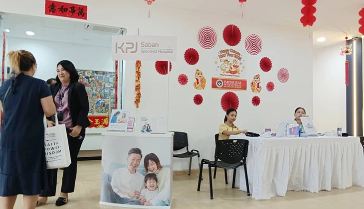 Staff at the KPJ Sabah Specialist Hospital information counter during a Chinese New Year celebration.